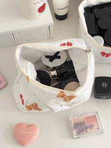 Detail of quilted bear makeup bag interior showing large capacity for cosmetics storage