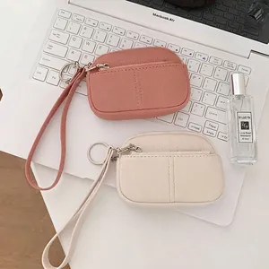 Mini portamonete in pelle martellata rosa e beige con cinturini da polso e anelli