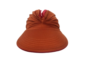Foldable orange sun visor with red lining showing detailed fabric texture on white background