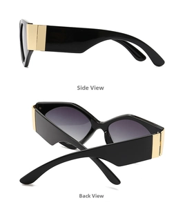 Detail of stylish oversized black sunglasses with luxury wide gold temple accents and grey lenses