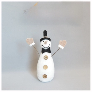 Close-up of handmade wool felt snowman ornament with black hat and wooden buttons