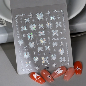 Detail of Fantasy Bow nail stickers featuring white ribbons and sparkling star motifs