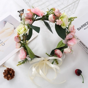 Detailed view of forest-style pink and white rose floral crown with silk ribbons