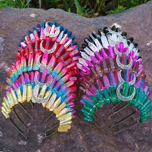 Detailed macro view of colorful electroplated crystal moon crowns on a natural rock surface