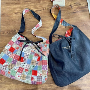 Top view of floral patchwork and blue denim tote bags on a natural wood surface