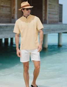 Detail of light beige men's resort shirt featuring textured vertical seams and Henley collar