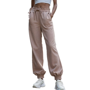 Detail of high waist polyester joggers with drawstring waist and elastic cuffs in khaki