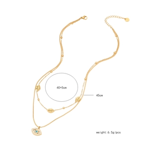 Detail of layered gold necklace with evil eye charms showing lengths 40+5cm and 45cm
