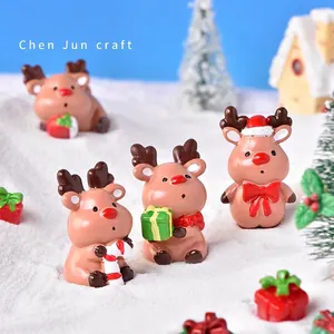 Miniature resin Christmas reindeer figurines set in artificial snow landscape scene