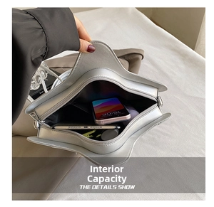 Star-shaped silver crossbody bag interior showing storage space for phone and tablet