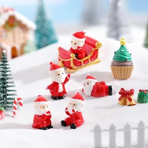 Miniature resin Christmas figurines set with Santa Claus and festive decor in snow scene