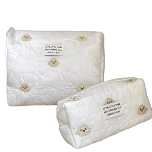 Quilted makeup bag set with yellow octopus embroidery and zipper closure in two sizes