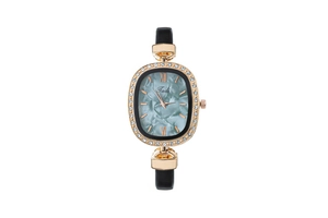Close-up of golden oval watch with diamond bezel and turquoise marble dial on black leather strap
