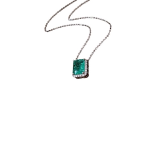 Elegant silver necklace with square emerald zircon pendant and diamond halo on white background