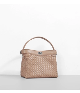 Detailed view of brown woven leather texture and elegant metallic twist lock closure