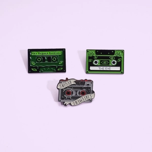 Set of three vintage Magnus Archives style green cassette enamel pins for backpacks