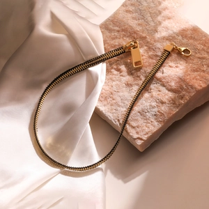Unique 18K gold-plated zipper design necklace on white silk and pink natural stone base