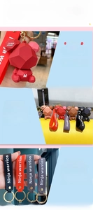Detail of geometric bear keychains in red, orange, brown and black with PVC matte finish