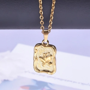Close-up of golden stainless steel necklace featuring a textured butterfly pendant