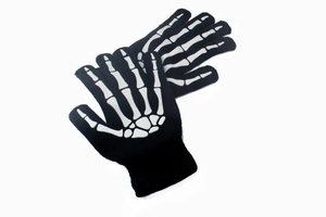 Close-up of knit skeleton gloves featuring white bone prints on black background