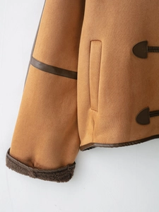 Close-up of brown faux suede jacket featuring horn buckle and thick faux shearling lining