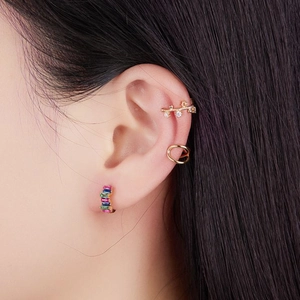 Golden earrings set with colorful rectangular zircons and minimalist ear cuff designs