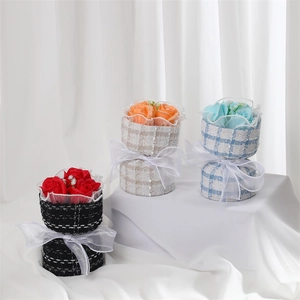 Three handmade soap flower bouquets in red orange and blue with tweed wrap and white ribbons