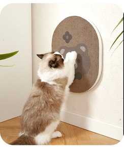 Wall-mounted oval corrugated cat scratcher with cute bear pattern and ragdoll cat