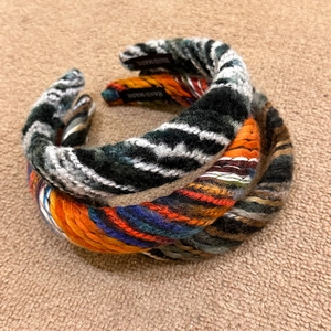 Chic multi-color knit headbands in vintage braided style on a soft beige background