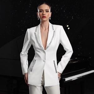 Detail of white slim-fit blazer showing silver metallic trim and crystal accents on lapels
