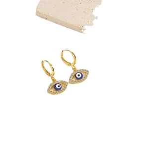 Exotic golden evil eye earrings with blue stones and clear zircons on white background