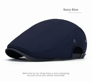 Detail view of navy blue flat cap featuring side metal eyelets and adjustable buckle strap