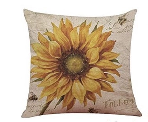 Close-up of linen cushion cover featuring vintage sunflower and bee oil painting prints