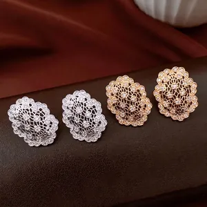 Vintage oval hollow stud earrings with zircon inlay in gold and silver plating