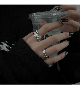 Detail of silver liquid-style irregular geometric open rings with a molten metal texture
