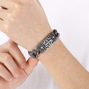 Vintage stainless steel men's curb chain bracelet featuring a gothic cross embossed plaque