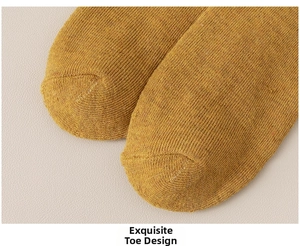 Detailed close-up of ginger yellow cotton knit toe seam on a durable sports sock