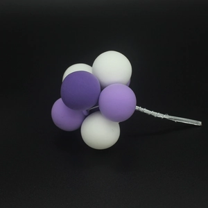 Colorful clay balloon cake topper with white and purple balls for birthday party decor