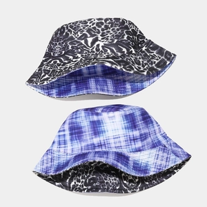 Reversible bucket hat with leopard print and blue plaid patterns for sun protection