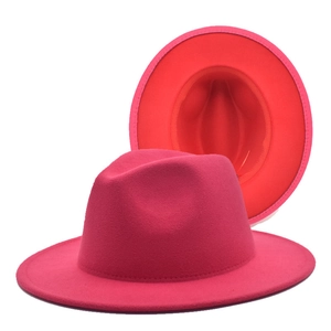 Detailed view of the vibrant rose red felt fedora with a contrasting red wide brim interior