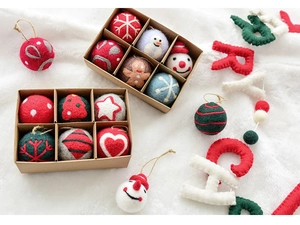 Close-up of wool felt Christmas ornaments showing detailed fiber texture and various shapes
