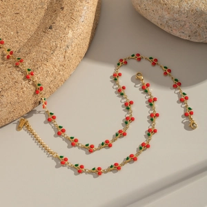 Detail of gold cherry necklace with red enamel beads and adjustable lobster clasp