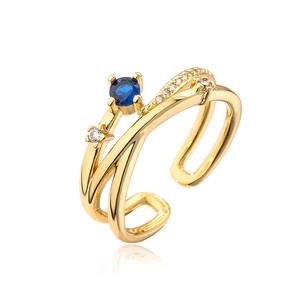 Irregular geometric open ring in gold finish with blue and white zircon stones