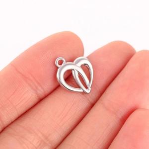 Detailed close-up of a silver stainless steel double heart pendant for DIY jewelry