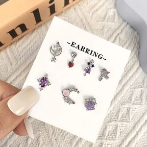 Detailed set of 7 silver studs with purple heart and moon crystals on display card
