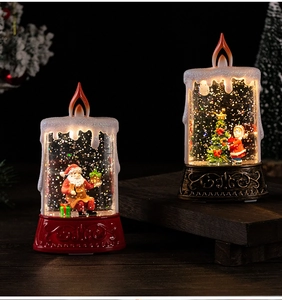 Macro view of illuminated Christmas water lanterns with Santa Claus and sparkling glitter