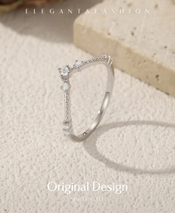 Close-up of V-shaped 925 sterling silver ring with moissanite stones and beaded texture