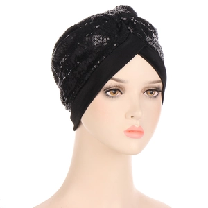 Close-up of black sequined turban hat featuring elegant cross-pleat design and shiny sequins