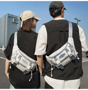 Outdoor shot of cream white crossbody sports chest bags on male and female models