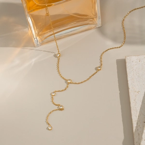Elegant gold Y-shaped tassel necklace with sparkling zircon stones on a chain